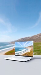 White Laptop Displaying Coastal Scene on Beach Background