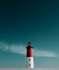 Lighthouse stands tall against the blue sky and serene landscape during sunset near the coast