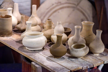 Porcelain vase clay embryos placed on the workbench in a Chinese ceramic production workshop.