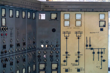 Old industrial control panel with analog meters, switches, and detailed electrical diagrams....