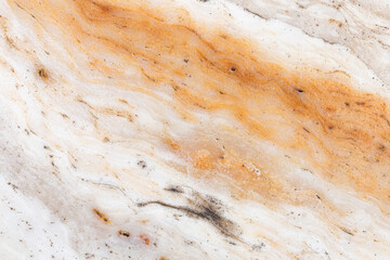 Close-up of natural orange and white marble stone surface showing detailed wavy patterns and mineral streaks, ideal for background, interior design, and texture reference.