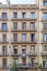 Obraz premium Classic Residential Building Facade With Balconies In Barcelona. Traditional architecture, urban living, European city, historic structure, ornate details