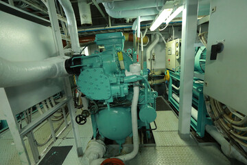Cruise ship engine room interior with water tight doors electrical and diesel engines, water pipes, measuring instruments, diesel engines