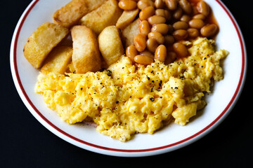 Scrambles Eggs With Baked Beans In Tomato Sauce And Thick Cut Fried Chips