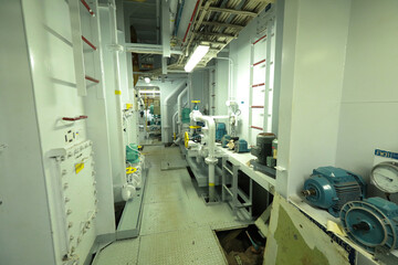 Cruise ship engine room interior with water tight doors electrical and diesel engines, water pipes, measuring instruments, diesel engines