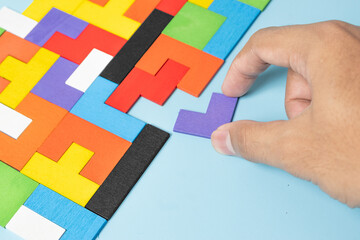 geometric shape block with colorful wood puzzle piece background. logical thinking, business logic, Conundrum, decision, solutions, rational, mission, success, goals and strategy concepts