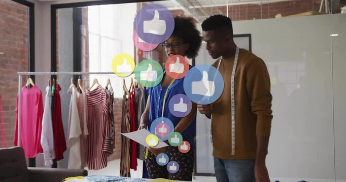 Fashion designers studying spec sheet while media icons rising around them indicating approval