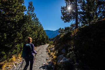 Young hiker woman in autumn in Aiguestortes and Sant Maurici National Park, Spain