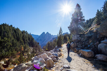 Young hiker woman in autumn in Aiguestortes and Sant Maurici National Park, Spain