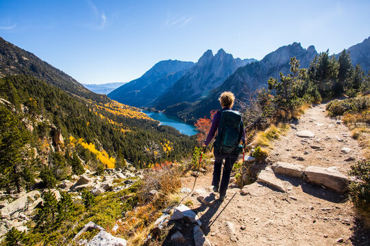 Young hiker woman in autumn in Aiguestortes and Sant Maurici National Park, Spain
