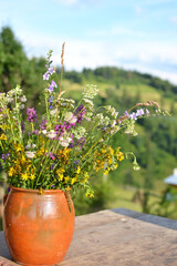 clay vase with wild flowers