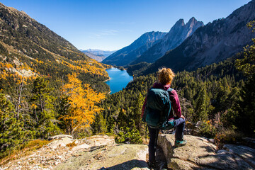 Young hiker woman in autumn in Aiguestortes and Sant Maurici National Park, Spain