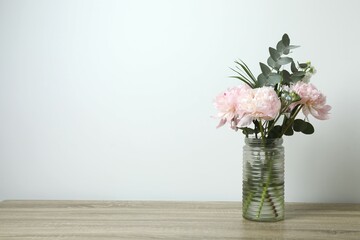 Beautiful bouquet with pink peonies in a vase on the table