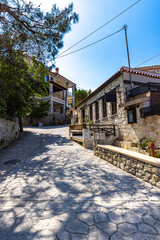 Traditional stone houses and quiet alley in Afitos, Greece