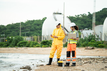 Environment scientist with team analysing waste water test results and collecting sample for research or inspection of the ecosystem and study of nature from an industrial factory into the sea