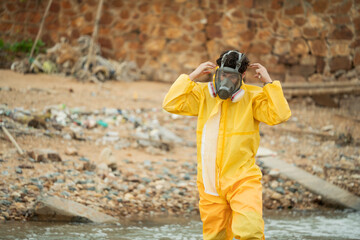 Environment scientist wearing chemical protective cloth and mask before working, Preparing for collecting sample in the waste water