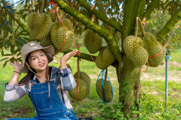 Durian farmer girl smiles sweetly to welcome Thai durian season