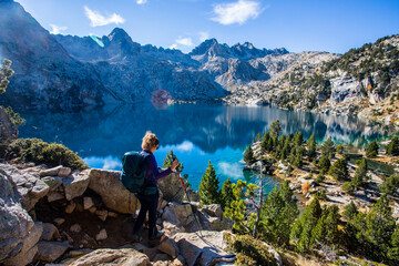 Young hiker woman in autumn in Aiguestortes and Sant Maurici National Park, Spain