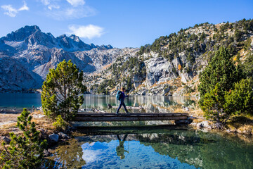 Young hiker woman in autumn in Aiguestortes and Sant Maurici National Park, Spain