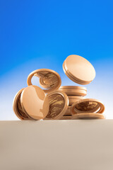 A grouping of shiny golden coins arranged in a balanced position against a backdrop of a clear blue...