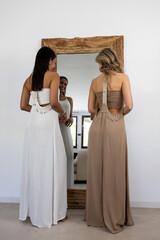 Model wearing a summer dress posing in front of a mirror.