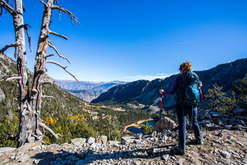 Young hiker woman in autumn in Aiguestortes and Sant Maurici National Park, Spain