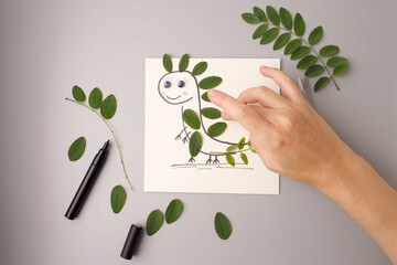 Leaf dinosaur character made by child for autumn craft project, suitable for preschool education, eco workshops, kids product packaging, creative tutorials, seasonal postcard design
