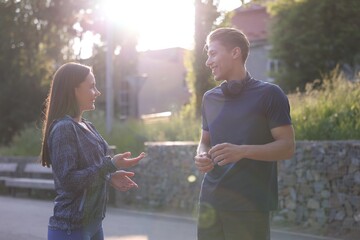 Couple in sportswear outdoors on sunny day. Healthy lifestyle