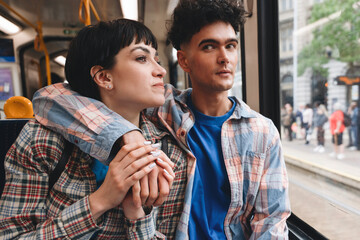 Couple enjoying a relaxing ride on public transport during the afternoon in a bustling city