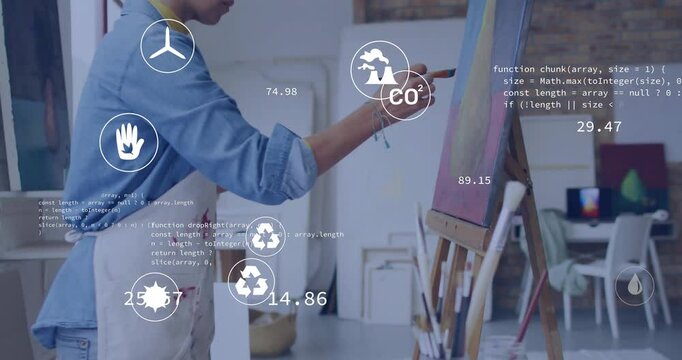 Woman artist dipping brush and painting canvas while blending live sustainability data overlays