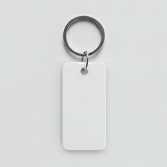 Minimalist white keychain tag with rounded edges and metal ring, isolated on light background, perfect for branding, labeling, or mockup use.