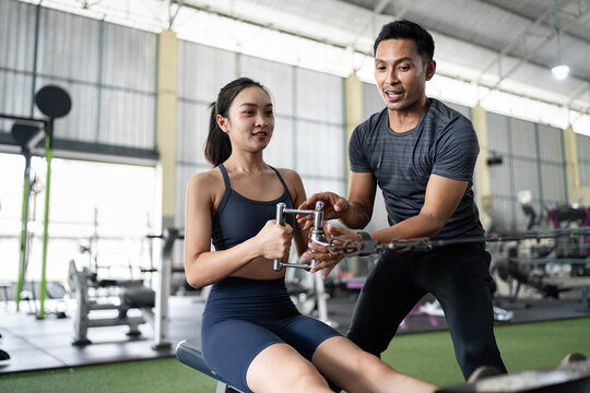 Personal Trainer Demonstrating Rowing Technique to Client