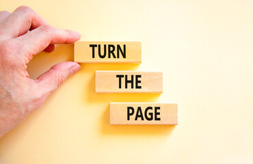 Turn the page symbol. Concept words Turn the page on beautiful wooden block. Businessman's hand....