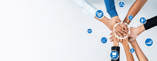 A diverse group of hands coming together symbolizes unity and collaboration in a professional...