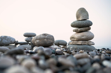 Stacked stones on a pebbled beach creating a tranquil and balanced natural scene