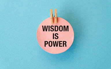 A pink sign that says Wisdom is Power text