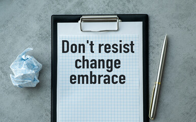 A clipboard with a piece of paper on it that says Don't Resist Change Embrace it.