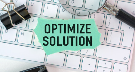 A green piece of paper with the word Optimize Solution written on it
