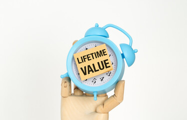 A blue alarm clock with a note that says Lifetime Value