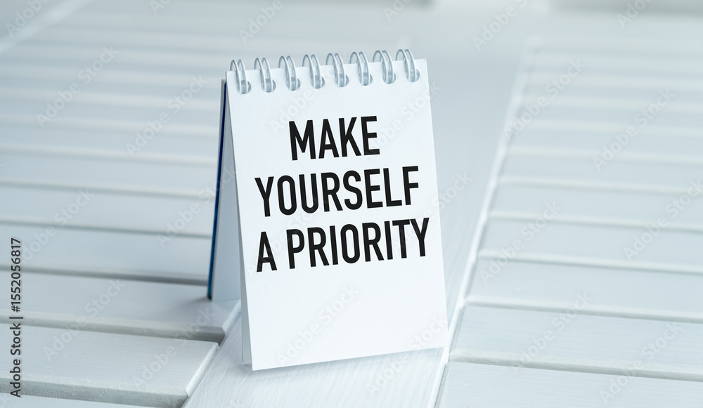 Poster a white notebook with the words make yourself a priority written on it