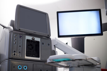 Medical equipment standing in operating room with large monitor and control panel visible, advanced...