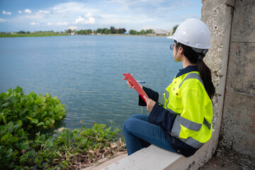 Environmental engineers work at the water storage plant, check the pH of the water, check the...