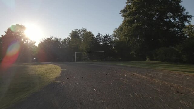Evening walk on a quiet soccer field near trees