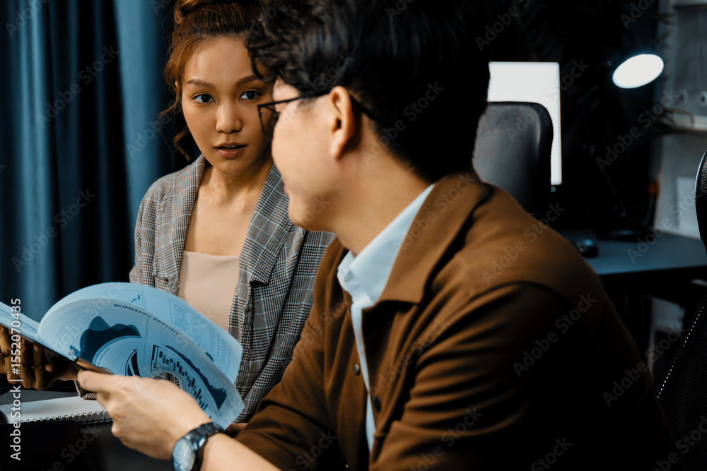 Aufkleber serious face of working sales manager discussing on report data analysis paperwork with coworker at 