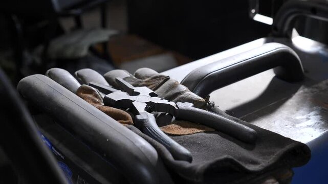 Tools and gloves on workshop bench
