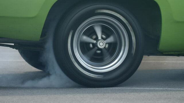 Car performs tire burnout in parking lot