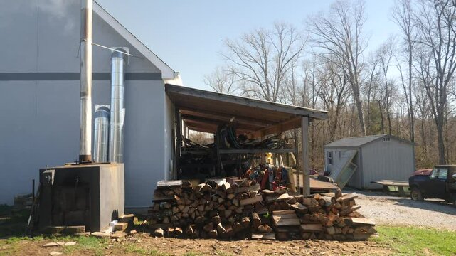 Wood storage area near a workshop in rural setting