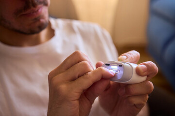 Close-up of an electric nail clipper in hand, modern personal care technology, highlighting compact...