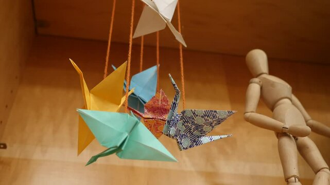 Colorful origami cranes hanging in a cozy studio