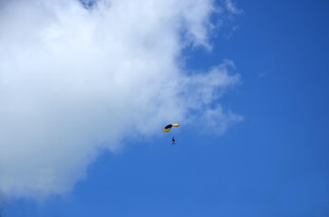 paraglider in the sky with clouds